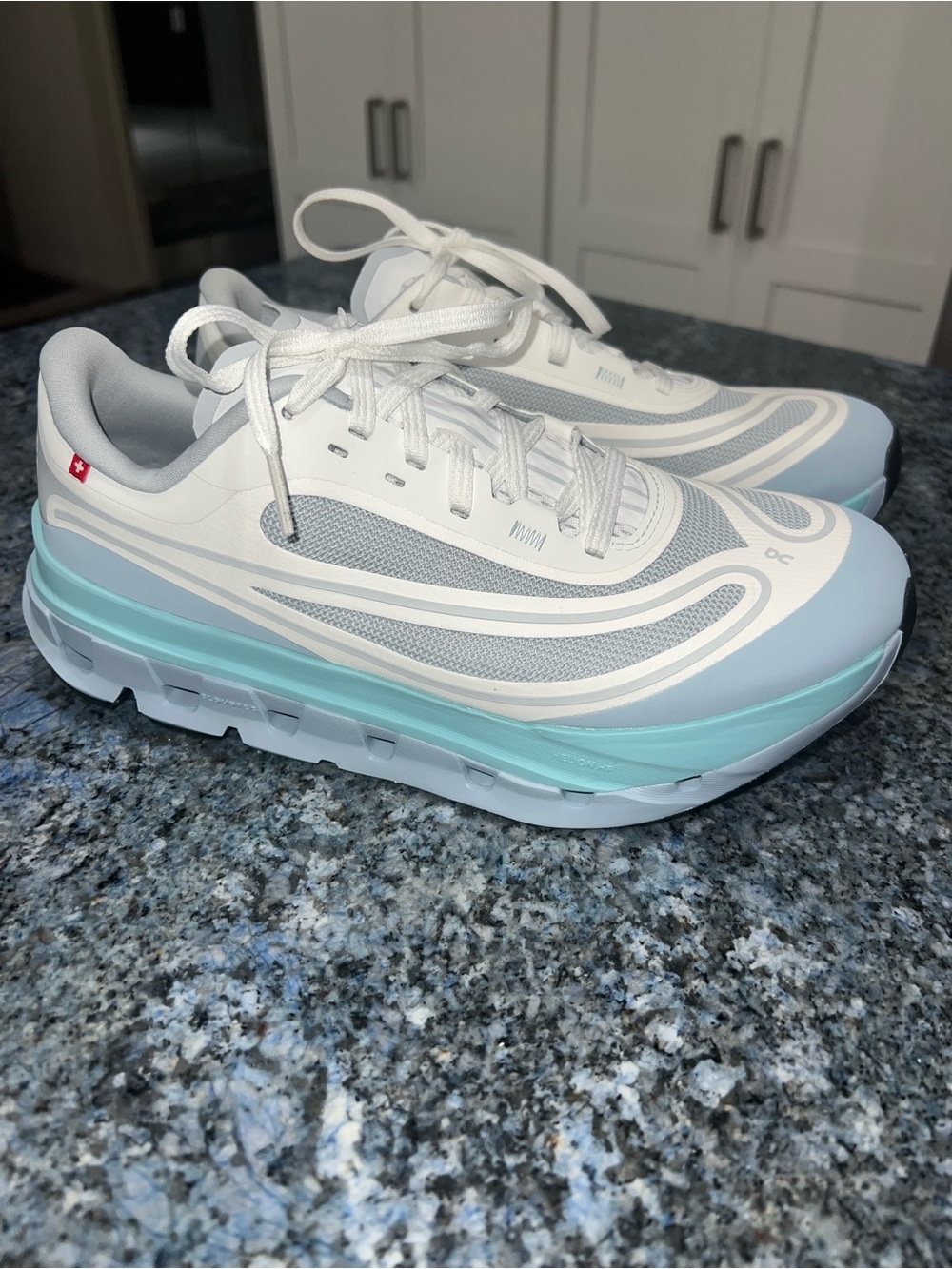 On Running Women's Cloudsurfer White with Light Blue Accent Sneakers